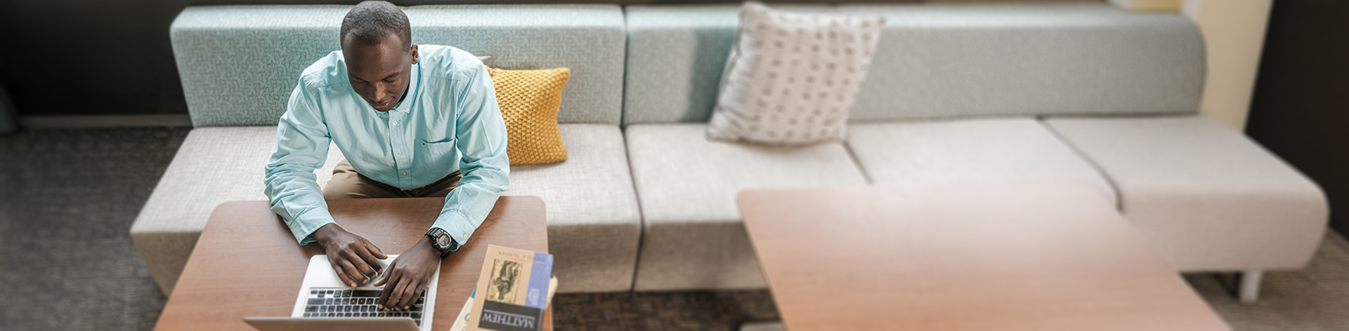 Student researching bible on computer