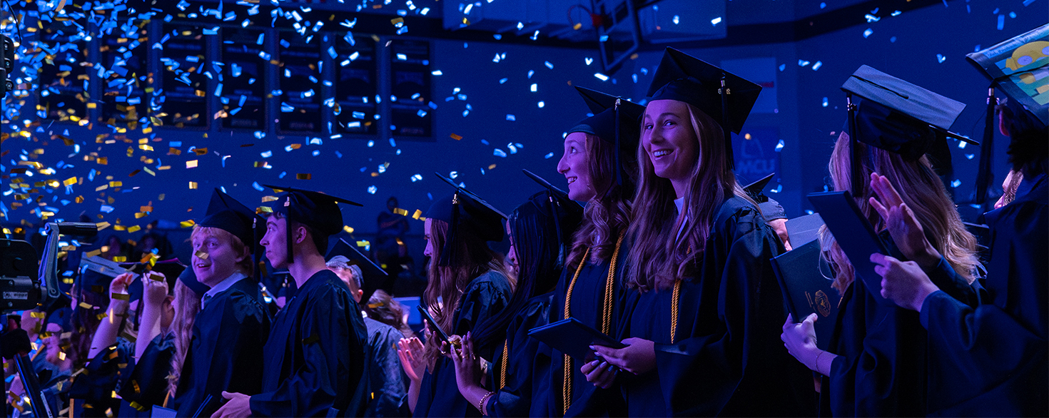 Graduates hold diplomas while standing under confetti at Cornerstone University's 84th Commencement on Saturday, May 9, 2026
